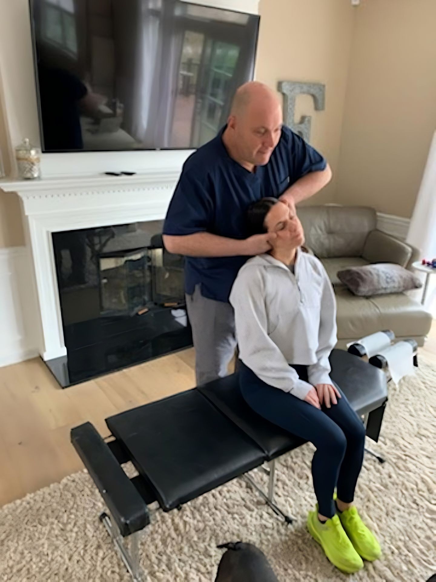 A chiropractic adjustment being performed on the neck